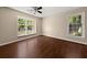 Cozy bedroom with hardwood floors and natural light streaming through two large windows at 2605 Vineyard Se Way, Smyrna, GA 30082