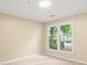 Bedroom with neutral carpet, light colored walls, and a window providing natural light at 2605 Vineyard Se Way, Smyrna, GA 30082