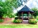 Community gazebo featuring a shaded seating area with a bench for enjoying the surrounding nature at 2605 Vineyard Se Way, Smyrna, GA 30082