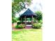Community gazebo featuring a shaded seating area with a bench for enjoying the surrounding nature at 2605 Vineyard Se Way, Smyrna, GA 30082