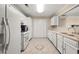 Efficient kitchen with white appliances, ample counter space, and tile flooring at 2605 Vineyard Se Way, Smyrna, GA 30082