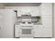 Bright kitchen featuring white appliances, cabinets, subway tile backsplash, and granite countertops at 2605 Vineyard Se Way, Smyrna, GA 30082