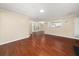Open-concept living room with hardwood floors, natural light, and view into kitchen area at 2605 Vineyard Se Way, Smyrna, GA 30082