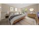 Comfortable main bedroom features neutral decor, a ceiling fan, and a sunny window at 2605 Vineyard Se Way, Smyrna, GA 30082