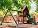 Community playground with a swing set, slide, and climbing structure, perfect for children at 2605 Vineyard Se Way, Smyrna, GA 30082