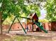 Community playground with a swing set, slide, and climbing structure, perfect for children at 2605 Vineyard Se Way, Smyrna, GA 30082