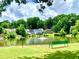 Scenic pond view with lush greenery, fountain, and bench for a relaxing community space at 2605 Vineyard Se Way, Smyrna, GA 30082