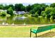 Scenic view of the community pond with a fountain, surrounded by lush trees and charming homes at 2605 Vineyard Se Way, Smyrna, GA 30082