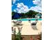 Community pool area with multiple sun loungers, umbrella-covered table, and a pool house at 2605 Vineyard Se Way, Smyrna, GA 30082