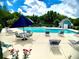 Community pool with patio furniture, sun loungers and vibrant roses in the foreground at 2605 Vineyard Se Way, Smyrna, GA 30082