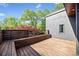 Exterior wooden deck showcasing built-in seating and a view of the green landscape at 265 Tara Trl, Atlanta, GA 30327