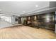 Finished basement with a decorative fireplace wall and light wood flooring at 265 Tara Trl, Atlanta, GA 30327
