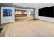 Finished basement with a bar, hardwood floors, and large screen tv at 265 Tara Trl, Atlanta, GA 30327