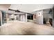 Spacious finished basement with a wet bar, wine storage, hardwood floors, and modern lighting at 265 Tara Trl, Atlanta, GA 30327