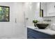 Modern bathroom boasts sleek fixtures, patterned tile, and a glass-enclosed shower at 265 Tara Trl, Atlanta, GA 30327