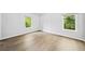 Bright bedroom with beautiful hardwood floors and natural light from two windows at 265 Tara Trl, Atlanta, GA 30327