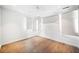 Minimalist bedroom with hardwood floors, roller shades, and modern lighting at 265 Tara Trl, Atlanta, GA 30327