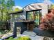 Modern home with unique architecture, a statement front door, and mature trees in a lush setting at 265 Tara Trl, Atlanta, GA 30327