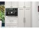 Kitchen detail featuring a Miele coffee maker and white cabinets with sleek hardware at 265 Tara Trl, Atlanta, GA 30327