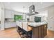 Open concept kitchen with a large island, modern lighting, and stylish bar stool seating at 265 Tara Trl, Atlanta, GA 30327