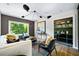 Comfortable living room with stylish decor, a modern light fixture, and serene outdoor views at 265 Tara Trl, Atlanta, GA 30327