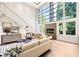 Bright and airy living room with large windows, a modern fireplace, and sleek contemporary furnishings at 265 Tara Trl, Atlanta, GA 30327