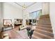 Open concept living room with stairs, an overlooking balcony, and an adjacent kitchen with modern island seating at 265 Tara Trl, Atlanta, GA 30327