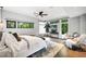 Sunlit main bedroom with large windows, stylish decor, hardwood floors, and a ceiling fan at 265 Tara Trl, Atlanta, GA 30327