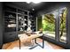 Well-appointed office with built-in shelving, modern desk, and a large window with natural light at 265 Tara Trl, Atlanta, GA 30327