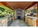The outdoor kitchen features a pizza oven and stone counters with a stone paver floor at 265 Tara Trl, Atlanta, GA 30327