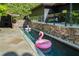Modern lap pool with stylish stone surround, featuring fun flamingo and swan floats at 265 Tara Trl, Atlanta, GA 30327