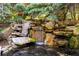 Backyard water feature with a stone waterfall and mature landscaping at 265 Tara Trl, Atlanta, GA 30327