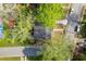 Aerial view showcases this home's landscaped lot, driveway, and proximity to neighboring homes at 3143 Church St, East Point, GA 30344