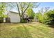 Large backyard with grass featuring a wood deck and plenty of tree coverage at 3143 Church St, East Point, GA 30344