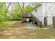 Spacious backyard with a deck and staircase, stone pavers, and a grassy yard at 3143 Church St, East Point, GA 30344
