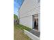 Walk-out basement access with stone paver entrance and gray painted siding on home at 3143 Church St, East Point, GA 30344
