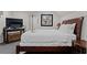 Well-lit bedroom featuring dark furniture, TV, and stylish decor at 3143 Church St, East Point, GA 30344
