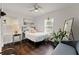 Cozy bedroom with ample natural light, stylish decor, and hardwood floors at 3143 Church St, East Point, GA 30344