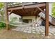 Relaxing backyard deck features a hammock and space for storage under the elevated deck at 3143 Church St, East Point, GA 30344