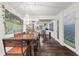Open concept dining area with modern light fixture and hardwood floors at 3143 Church St, East Point, GA 30344