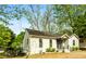 Charming home exterior with mature trees, lush greenery, and inviting curb appeal at 3143 Church St, East Point, GA 30344