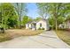 Charming home with a well-maintained lawn, modern updates, and a paved driveway at 3143 Church St, East Point, GA 30344