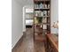 Inviting hallway with hardwood floors, open shelving, leading to a bedroom at 3143 Church St, East Point, GA 30344