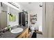 Bathroom featuring a sink with natural wood vanity, tile floors, toilet, tub and decorative shelves and plants at 69 Due West Pass, Dallas, GA 30157