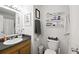 Bathroom with sink and wood vanity, toilet, mirror, shelf, white walls, and modern decor at 69 Due West Pass, Dallas, GA 30157