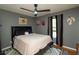 This bedroom features a modern ceiling fan, a baseball decor, and a comfortable-looking bed and area rug at 69 Due West Pass, Dallas, GA 30157