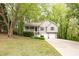 Inviting two-story home featuring a covered front porch and an attached two-car garage at 69 Due West Pass, Dallas, GA 30157