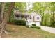 Traditional two-story home with a covered porch, two-car garage, and lush landscaping at 69 Due West Pass, Dallas, GA 30157