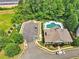 Beautiful aerial view of the community pool, clubhouse, parking and play area surrounded by lush trees at 8275 Majors Ridge Way, Cumming, GA 30041