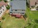 Aerial view of the home showcasing a large backyard with deck and mature landscaping at 8275 Majors Ridge Way, Cumming, GA 30041
